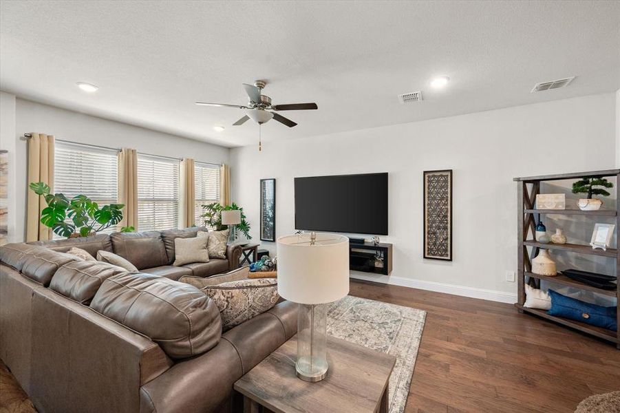 Living room featuring ceiling fan and dark hardwood / wood-style floors