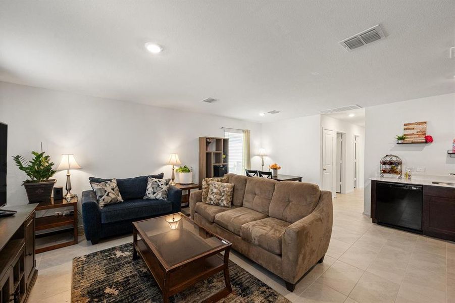 Living room featuring sink and light tile patterned floors