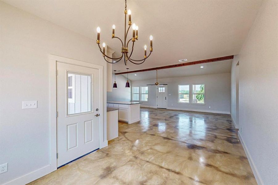 Foyer with ceiling fan with notable chandelier