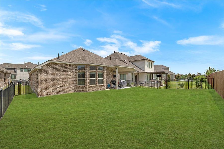 Back of house featuring a patio and a yard