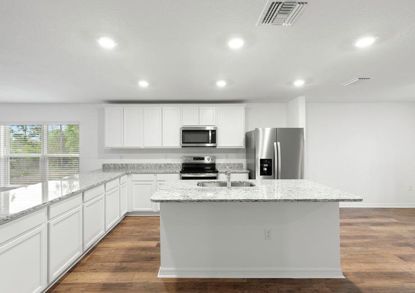 The kitchen has beautiful white cabinets