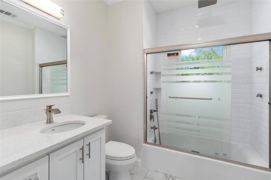 Downstairs bath with extra shower heads and whirlpool tub