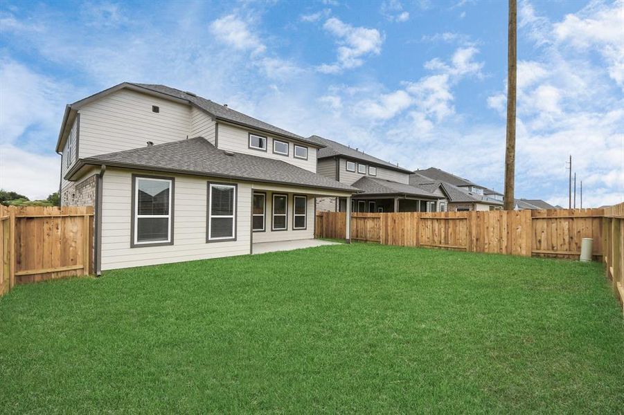 Discover the charm of this spacious backyard featuring a delightful covered patio. With ample room for both play and relaxation, it's the perfect outdoor haven.