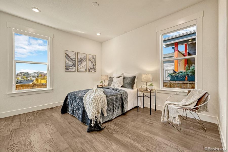 A third bedroom is found on the main level and offers luxury vinyl plank flooring, windows allowing light to shine in, a walk-in closet and easy access to a bathroom.