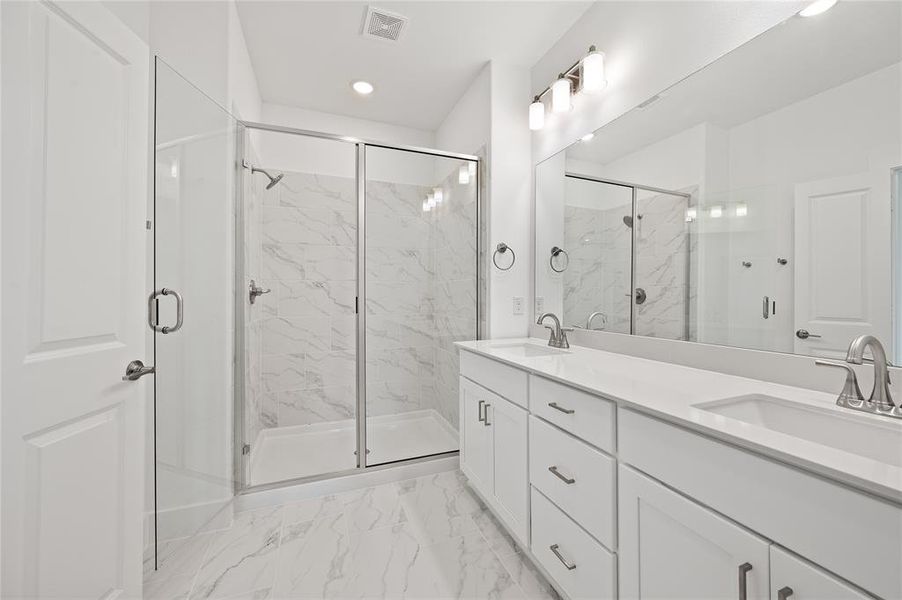 With an oversized walk in shower and double vanity, you'll find it all in this lovely owner's bath!