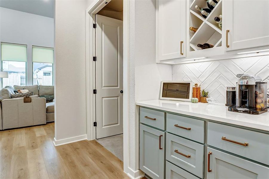 Store your wine in the custom wine rack built into the hutch with quartz countertops perfect for a coffee bar and to store small appliances and china.