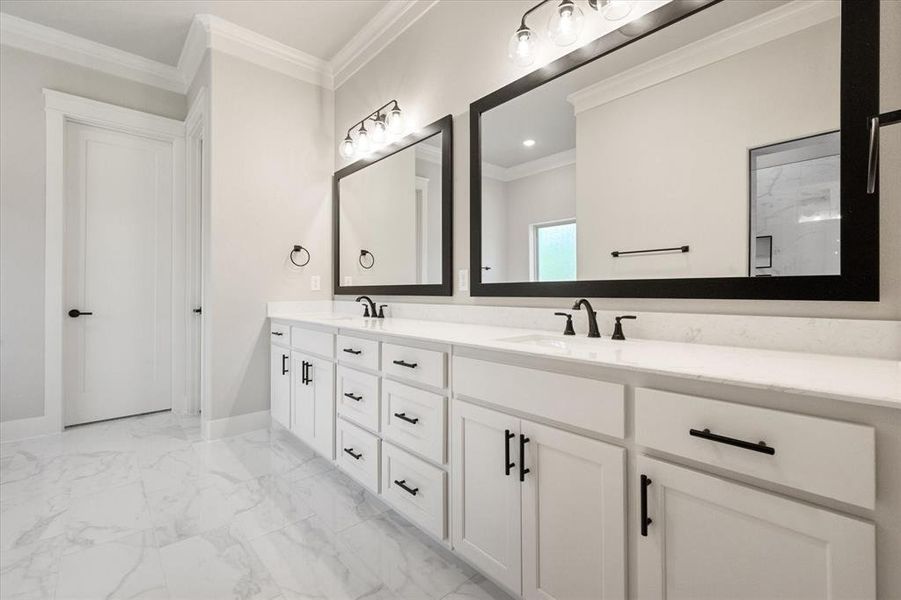 Bathroom featuring crown molding and vanity!