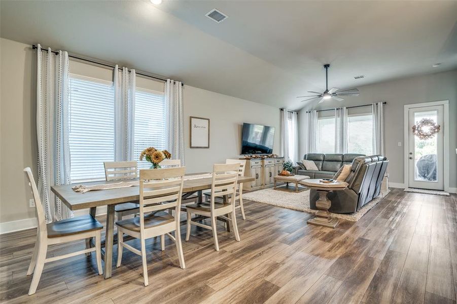 Dining space featuring ceiling fan, hardwood / wood-style floors, and a healthy amount of sunlight