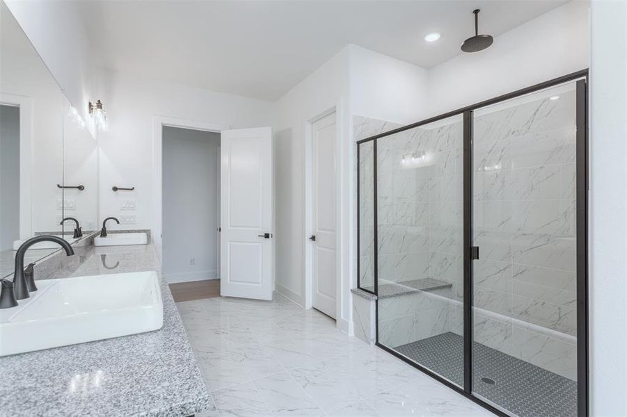 Bathroom featuring vanity and a shower with shower door