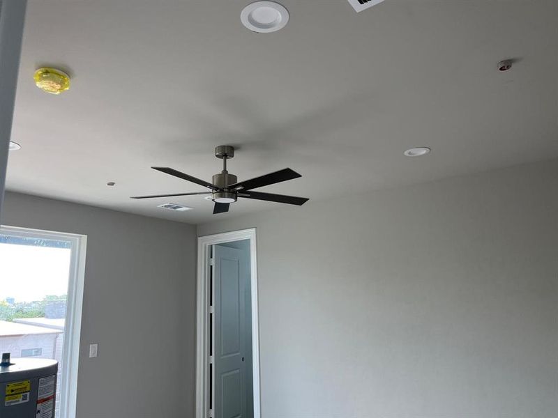 Room details with water heater and ceiling fan