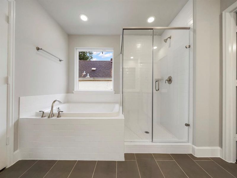 The Primary Bath is highlighted by the spacious shower and the separate soaking tub. Enjoy a nice bubble bath after a long day! **1511 Auline will have a free-standing bathtub (Sample photo of a completed Sterling Floor Plan. Image may show alternative features/and or upgrades.)