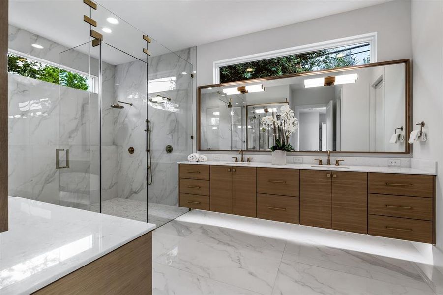 Bathroom featuring double vanity, an enclosed shower, tile patterned flooring, and a healthy amount of sunlight