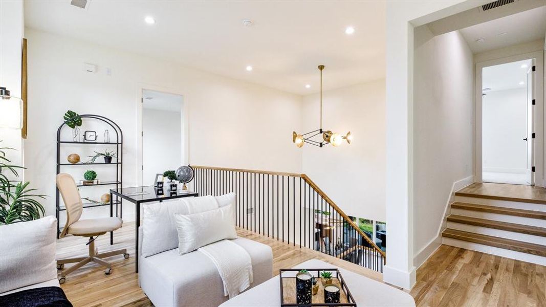 Sitting room featuring light hardwood / wood-style floors and a notable chandelier