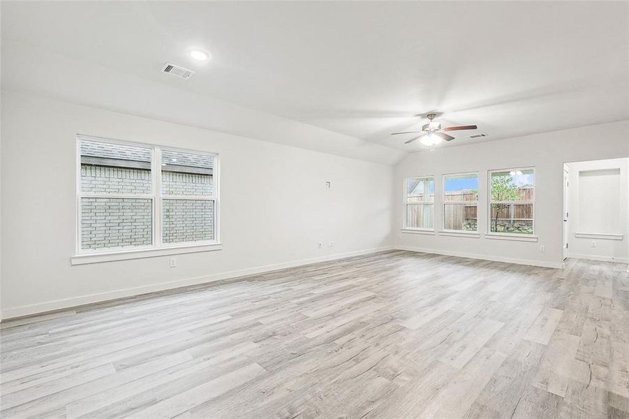 Unfurnished living room featuring ceiling fan and light wood-type flooring