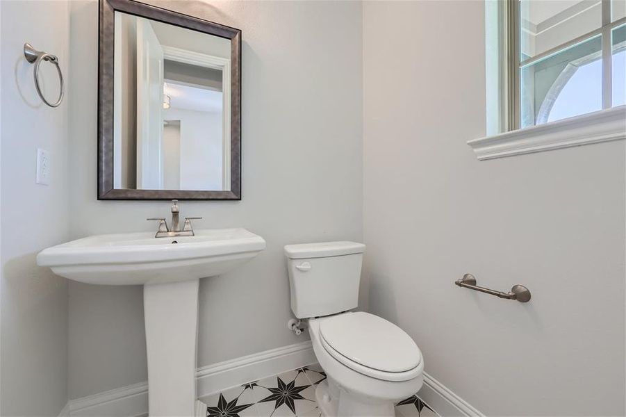 Bathroom with toilet and tile patterned floors