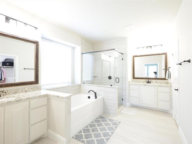 Bathroom featuring vanity and plus walk in shower