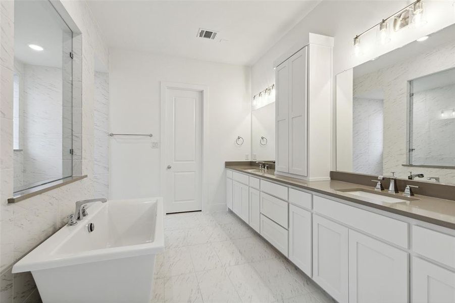 With his and her vanities, there is plenty of room for 2 in this lovely owner's bath.