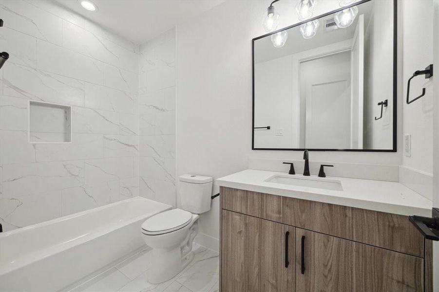 All secondary bathroom are right off of the secondary bedrooms featuring European cabinetry, quartz countertops, crafted hardware, and a shower/bath combination!