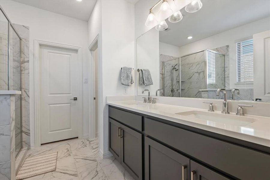 Bathroom featuring vanity and a shower with door