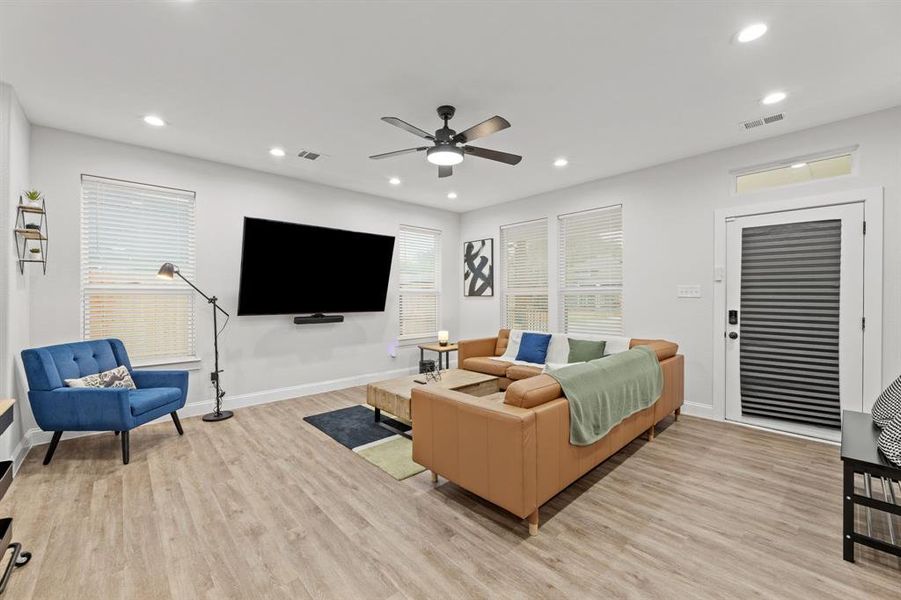 Living room featuring light wood-type flooring and ceiling fan