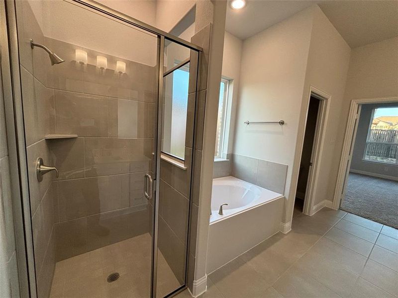 Bathroom featuring plus walk in shower and tile patterned floors