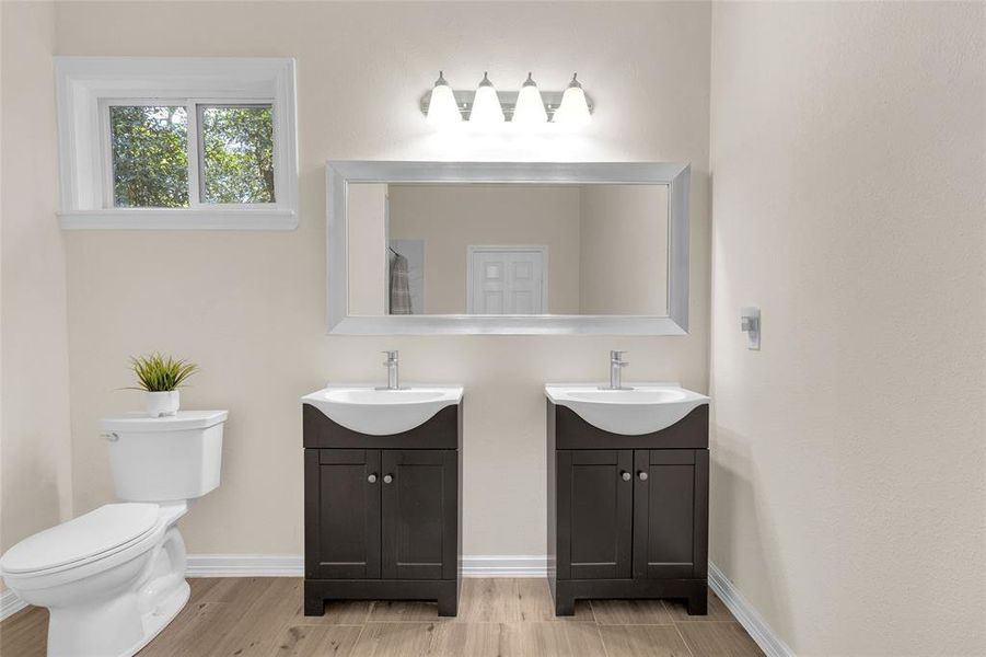 Modern bathroom with neutral tones, featuring a dual vanity with great cabinetry designs.