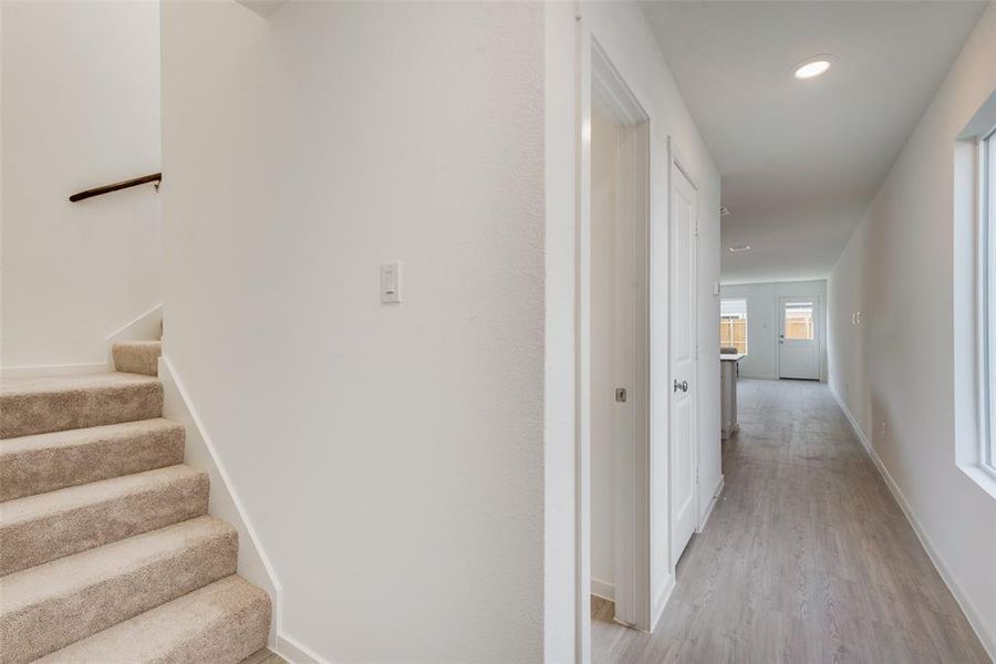 Hall with light hardwood / wood-style flooring