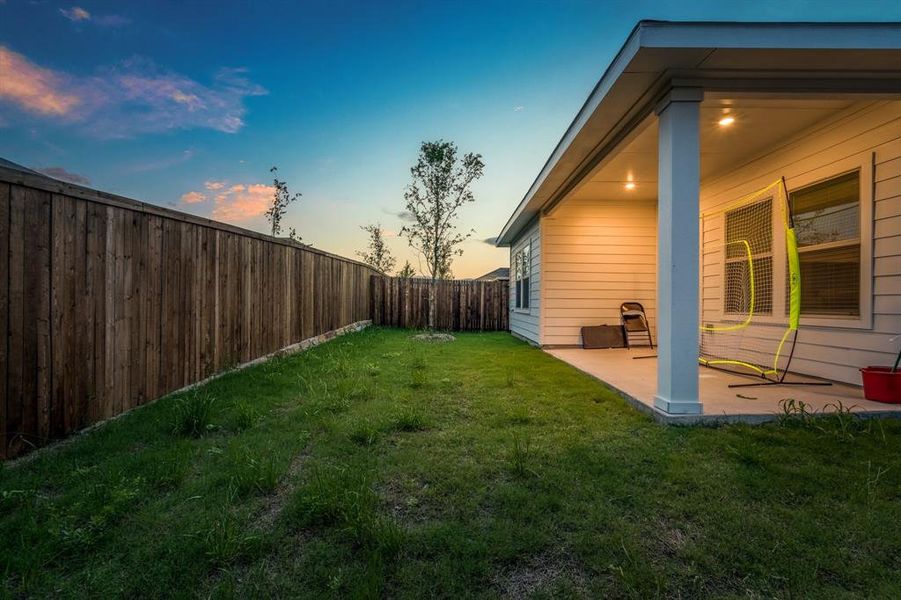 Yard at dusk with a patio area