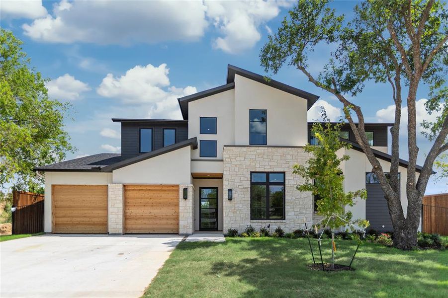 Modern home with a garage and a front lawn