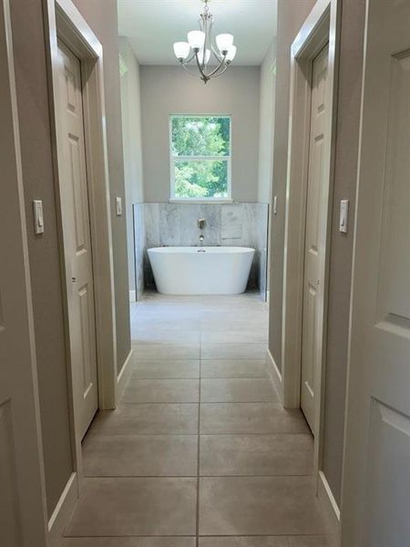 Open the doors from the bedroom to see this luxurious free standing tub surrounded in marble