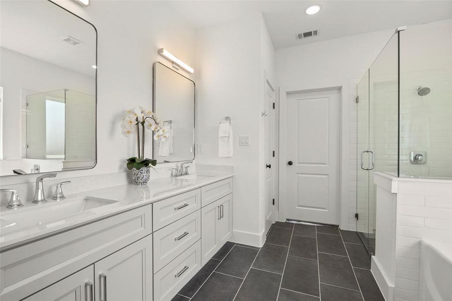 Bathroom with plus walk in shower, tile flooring, oversized vanity, and double sink