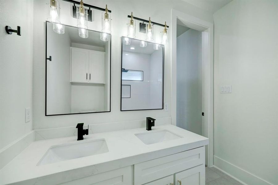 The guest bath features double a double vanity.