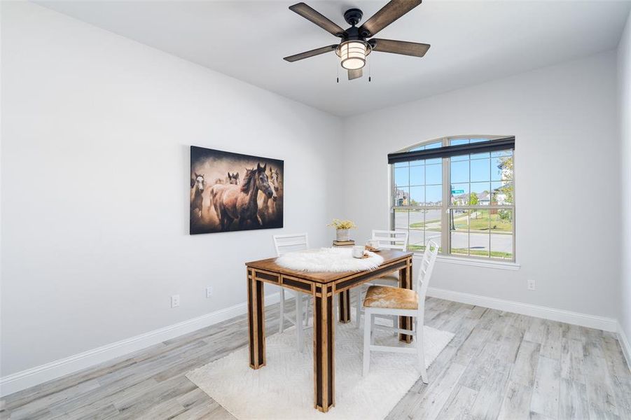 Unfurnished dining area featuring light hardwood / wood-style floors and ceiling fan