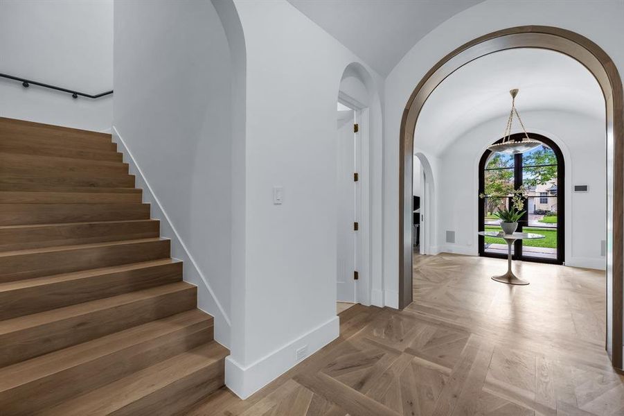 Foyer with lofted ceiling and parquet floors