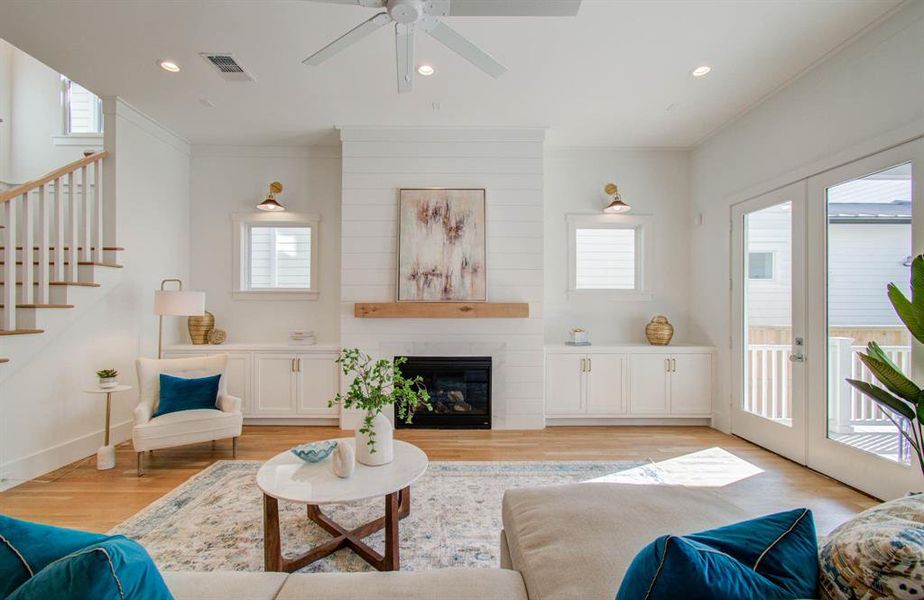 Custom built in cabinets,Solid wood mantel, gas fireplace, modern celling fan, shiplap over the fireplace.