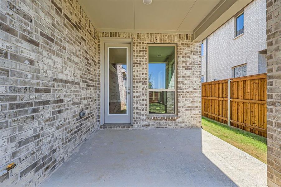 View of exterior entry featuring a patio area