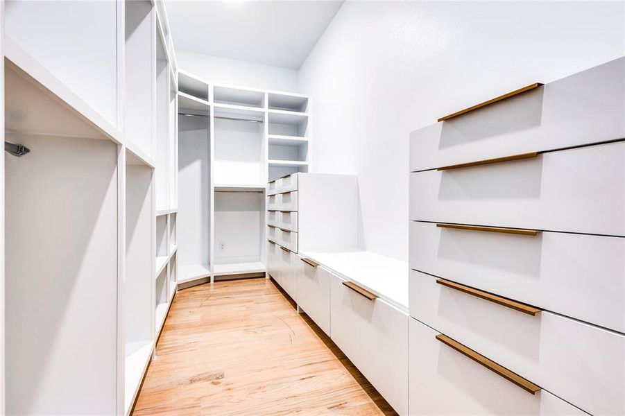 Spacious closet with light hardwood / wood-style floors