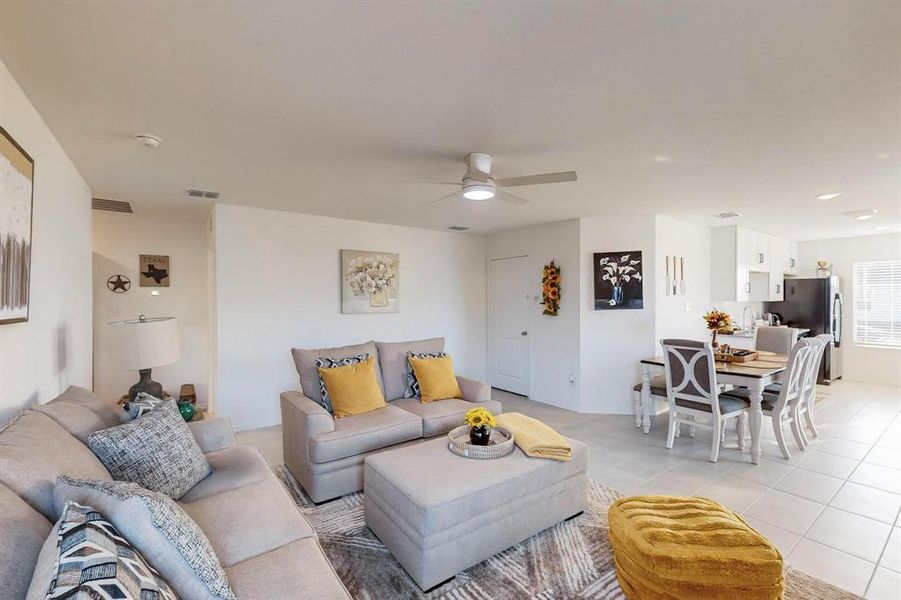 Living room featuring sink, light tile patterned floors, and ceiling fan