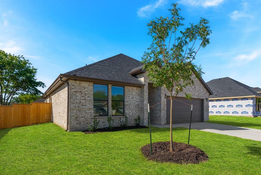 View of front of property with a front yard and a garage