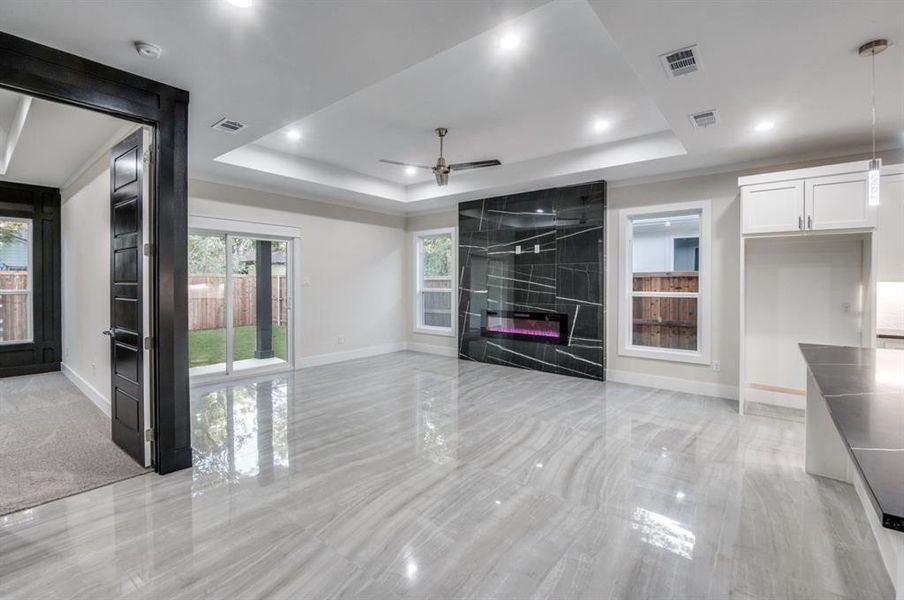 Breathtaking ultra contemporary and glossy floors with abundance of natural lighting with a sliding door to your backyard with a large covered porch!