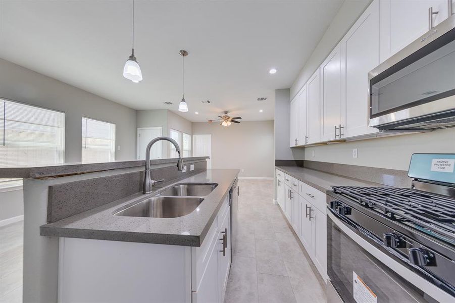 The spacious kitchen is a chef’s dream, offering plenty of room for meal prep, cooking, and entertaining. With ample counter space, modern appliances, and abundant cabinetry, this kitchen is designed to make both everyday cooking and hosting gatherings a breeze. Its open layout ensures that it remains the heart of the home, perfect for family meals and socializing.