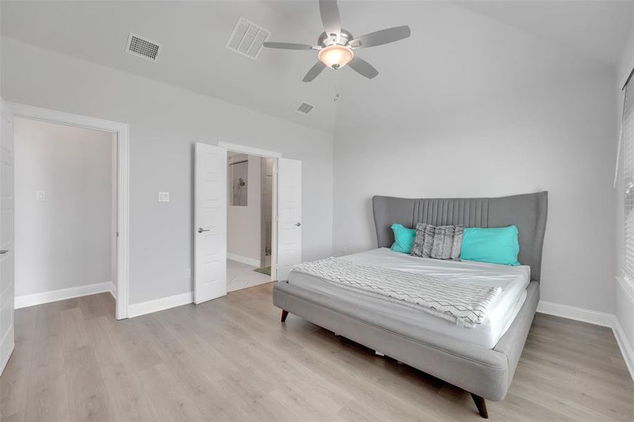 Bedroom featuring lofted ceiling, light hardwood / wood-style floors, and ceiling fan