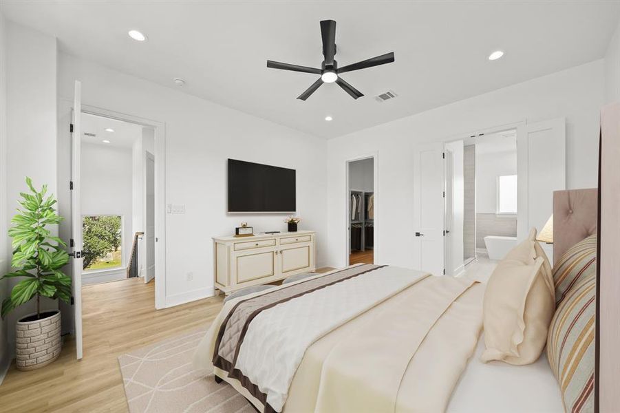 Virtually Staged: Spacious primary bedroom located on the third floor, featuring recessed lighting, a ceiling fan, and luxury vinyl plank floors.