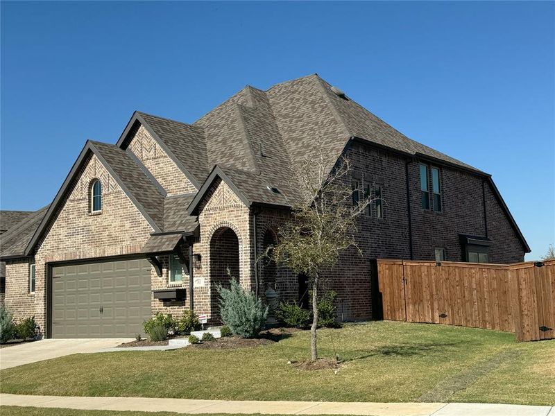 View of front of property with a front yard and a garage