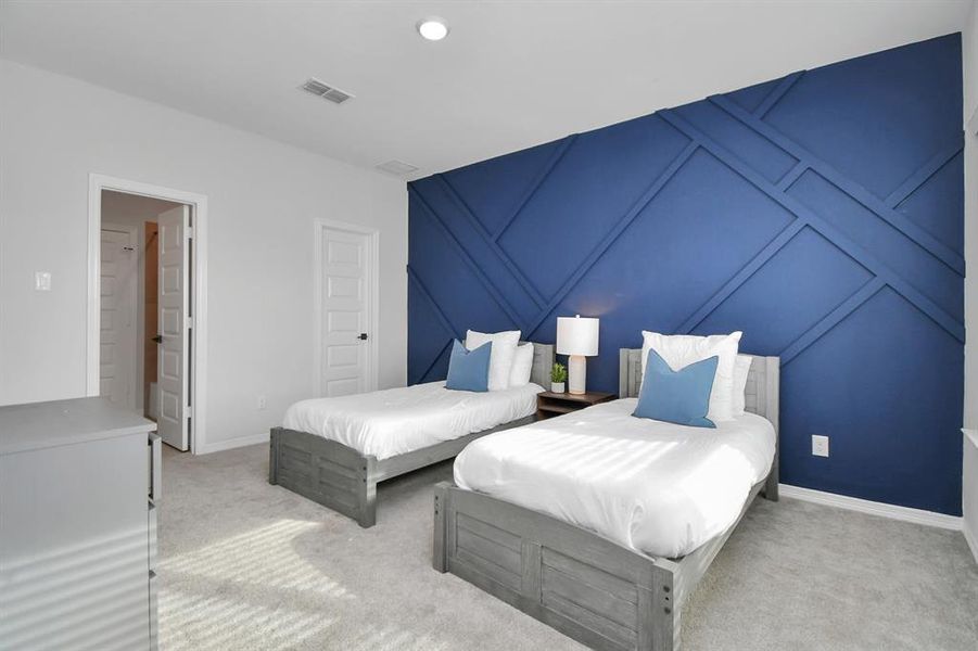 The fifth bedroom features plushcarpet, large windows, and customaccent wall.