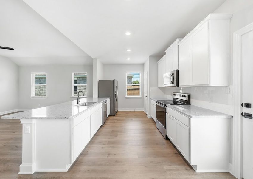 The kitchen of the Reed floor plan has energy-efficient appliances and white wood cabinetry.