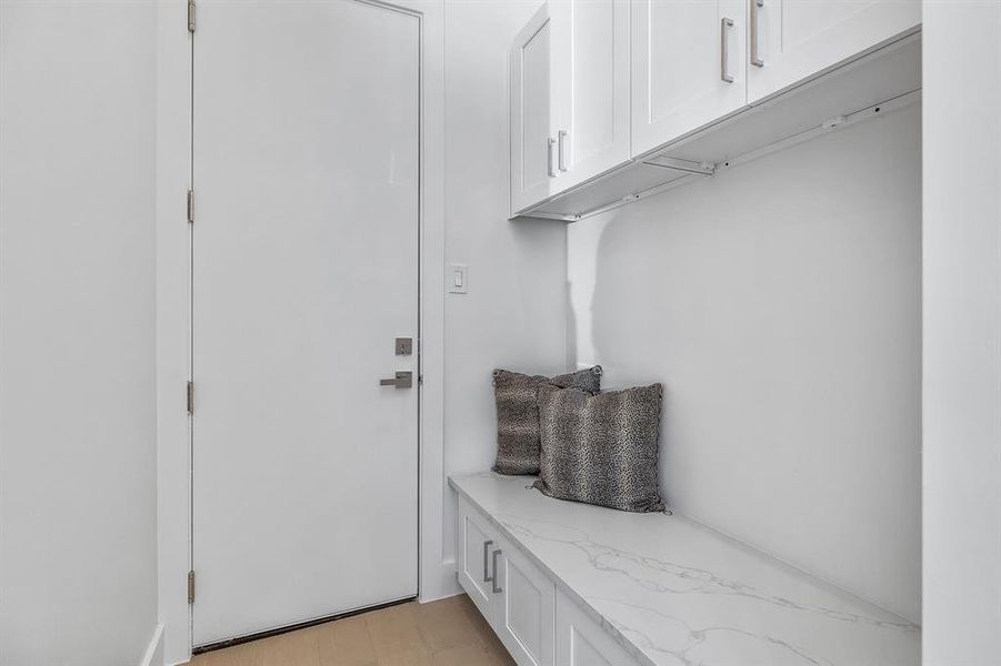 Mudroom with light hardwood / wood-style floors