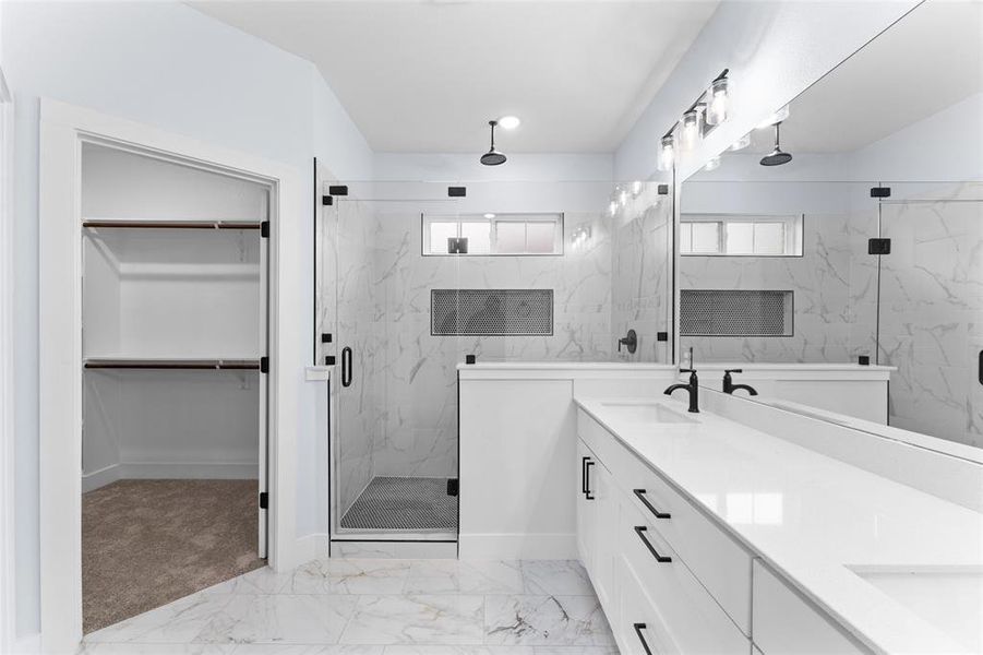 Bathroom with plenty of natural light, an enclosed shower, and vanity