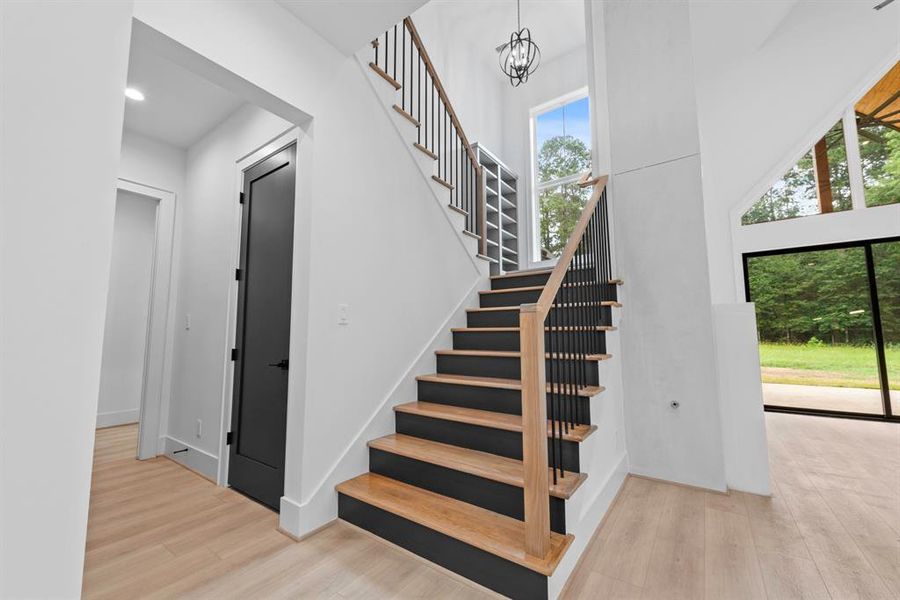 Under stairs huge storage closet with additional double door storage closet across leading to the primary bedroom.