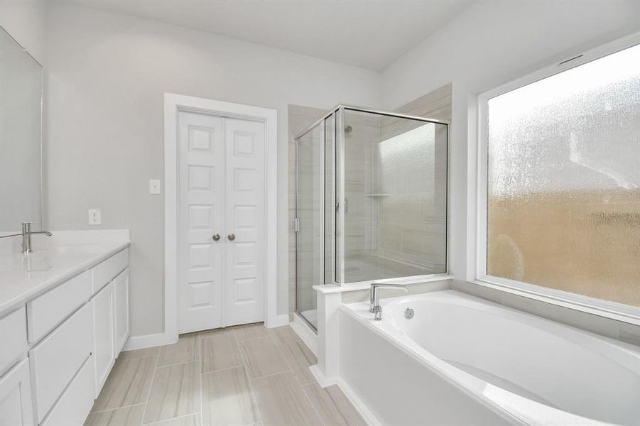 The primary en-suite has a soaking tub to give you that spa experience. The large privacy window allow lots of nature light in the space.